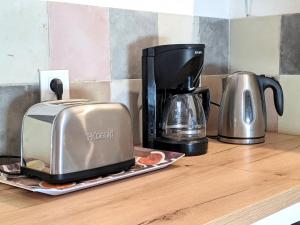 a toaster and coffee maker sitting on a counter at Le Mas du Tes in Saint Sebastien d'Aigrefeuille