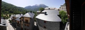 an aerial view of a building with mountains in the background at Apartamentos Casa Cecilia in San Juan de Plan