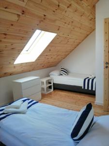 a bedroom with a bed and a skylight at Domek Mikołajki in Mikołajki