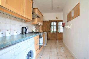 a kitchen with a washer and dryer in it at Charming 4-Bed Pet Friendly House in Liverpool in Liverpool
