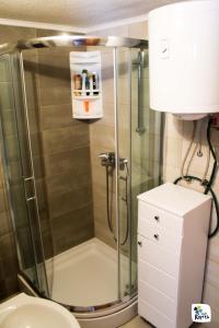 a shower stall in a bathroom with a toilet at Apartman Adria 2 in Kupres