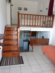 a bedroom with a wooden staircase and a bed at Level Houses in Kefalos