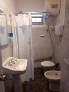 a bathroom with a sink and a toilet and a window at Casa en el centro de La Paloma in La Paloma +6 photos