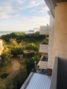 a balcony of a house with a view of the ocean at Apart Amabile Sul Mare in Villa Gesell