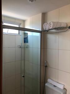 a bathroom with a glass shower and a toilet at Flat vista Mar in João Pessoa