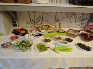 a table with different types of food on it at Osrodek Wypoczynkowy " BIESZCZADY" in Myczkowce