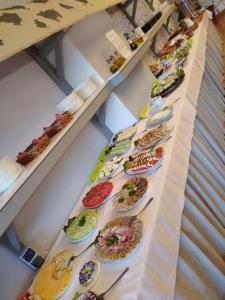 uma mesa longa com pratos de comida em Osrodek Wypoczynkowy " BIESZCZADY" em Myczkowce