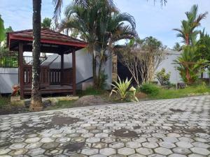 a house with a gazebo on the side of a road at Oemah Sadewa Homestay in Karangkandri