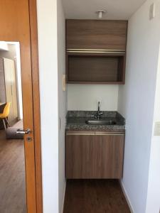 a small kitchen with a sink in a room at Flat vista Mar in João Pessoa
