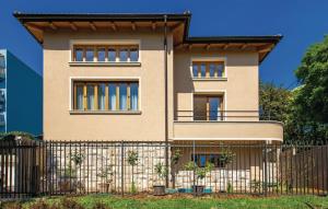 a house with a fence in front of it at Apartman Villa Pećine in Rijeka