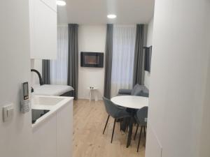 a kitchen and a living room with a table and chairs at City Center Main Square Apartments Zagreb in Zagreb +83 photos