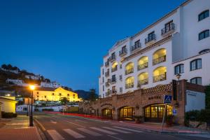 un edificio sul lato di una strada di notte di Hotel Villa Frigiliana a Frigiliana