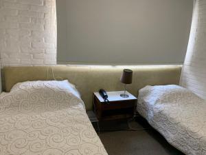 A bed or beds in a room at Punta del Este Shelton Hotel