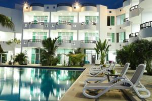 a hotel with a swimming pool and lounge chairs at Costa Madero Resort in Los Ayala