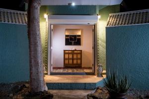 a door to a house with a palm tree at Chateau Nightwind in Lovenlund