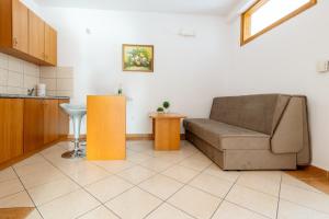 a living room with a couch and a table at Apartments Knežević in Neum +80 photos