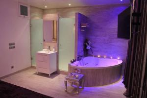 a large bathroom with a tub and a sink at Romantic Barcelona Apartment in Barcelona