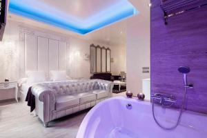 a large bathroom with a tub and a bed at Romantic Barcelona Apartment in Barcelona +2 photos
