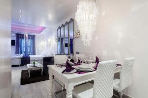 a white dining room with a white table and chairs at Romantic Barcelona Apartment in Barcelona