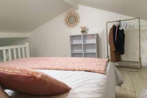 - une chambre avec un lit et une couverture rose dans l'établissement Appartement neuf entre mer et montagne., à Furiani