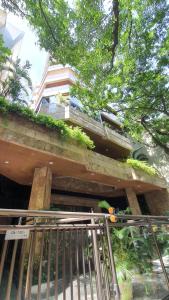 a building with a balcony with plants on it at Ocean Flat in Rio de Janeiro