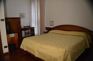 Postel nebo postele na pokoji v ubytování Hotel Sagittario