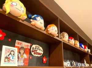 a wooden shelf with stuffed toys on it at Hotel Trend Numazu Ekimae in Numazu