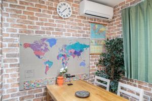 a brick wall with a map of the world on it at nestay inn tokyo senju in Tokyo