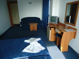 a hotel room with a bed with a towel on it at Guesthouse Ruskovi in Ravda