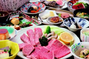 a table with a bunch of different types of food at Minshuku Asogen in Aso