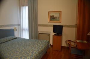 Postel nebo postele na pokoji v ubytování Hotel Sagittario