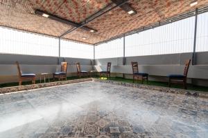 a swimming pool with chairs and tables in a tent at OSI Apartments Jogeshwari West in Mumbai