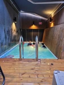 a group of people swimming in a swimming pool at Louis Boutique Hotel in Changwon