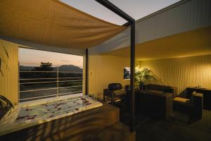 a room with a large window with a large pool at Villa COLORS by Relapool in Inbu +149 photos
