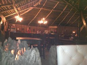 a dining room with a table and a fire place at Hotel O Sole Mio in Assinie