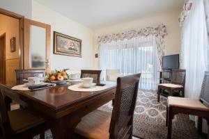 a dining room with a wooden table with chairs and a dining room at Paradiso Al Mare shared pool - Happy Rentals in Diano Marina