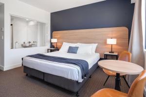 a hotel room with a bed and a table at Springs Newcastle in Newcastle +19 photos