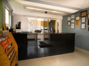 a bar in a room with a counter at Hotel Regis in Mexicali