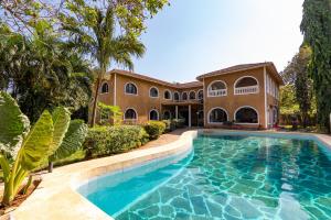 an exterior view of a house with a swimming pool at JoysVilla Family Holiday Home in Malindi
