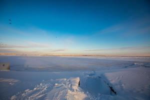 a view of a large body of water with snow at Prionezhsky Club Hotel in Petrozavodsk