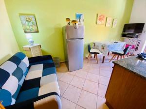 a kitchen with a refrigerator and a table with chairs at Le case di Helga in Budoni