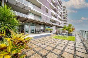an exterior view of a building with plants at Cairns Waterfront Luxury at Harbourlights in Cairns
