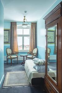 a bedroom with a bed and a table and a window at Nina Kordon Guesthouse in Alatskivi