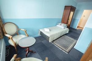 a room with a bed and a chair and a table at Nina Kordon Guesthouse in Alatskivi