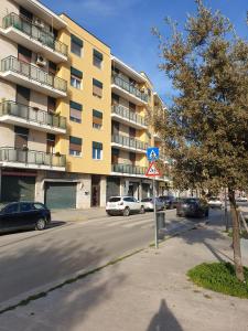 a street with cars parked in front of a building at Garibaldi House - B&B Luxury in Acquaviva delle Fonti