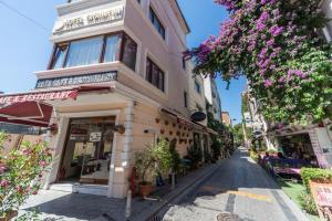 a building on the side of a street with flowers at Tayahatun Hotel in Istanbul