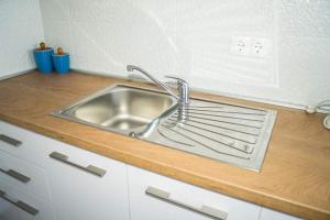 a kitchen sink with a metal rack next to it at Apartmani Juricev Vodice in Vodice +17 photos