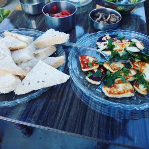 a table topped with two plates of food with bread at La Casa Art Stay in Udaipur