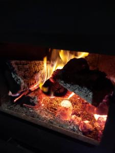 a fire in a brick oven with flames at Vikendica Vlahović in Kolašin