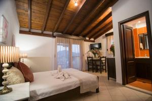a bedroom with a bed with a towel on it at Afrodite Hotel Apartments in Myrina